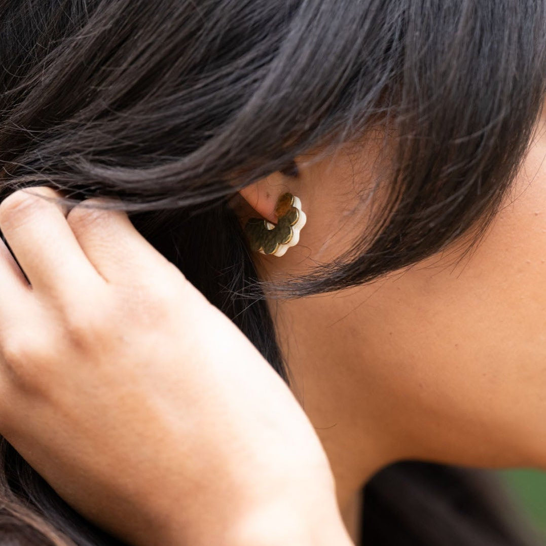 Bring a touch of charm to your style with our Daisy Huggie Ankole Earrings. Designed to gently “hug” your ears, these sweet blooms are handmade in brass with a satin-brushed finish, sterling silver posts, and ankole blooms carefully adhered to the brass.