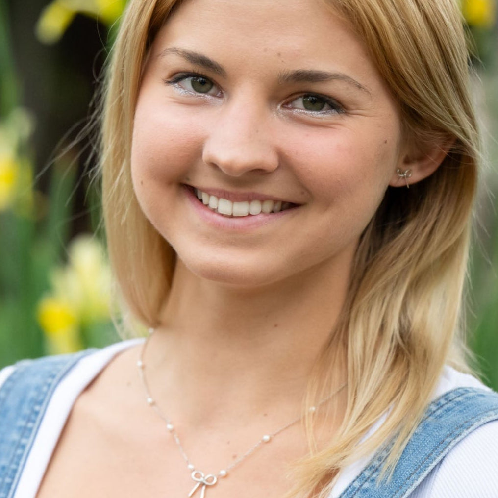 Simple yet meaningful, these dainty hand-forged bows are perfect for everyday wear. Symbolizing resilience and strength, the bow serves as a reminder of lives beautifully tied together through hope and freedom. Each stud is carefully shaped by hand and finished with sterling silver posts for comfort and durability.

Hand-cut, hammered, and assembled by a young woman in India rebuilding her life after human trafficking, every pair carries her story of courage and dignity. Your purchase supports her journey t