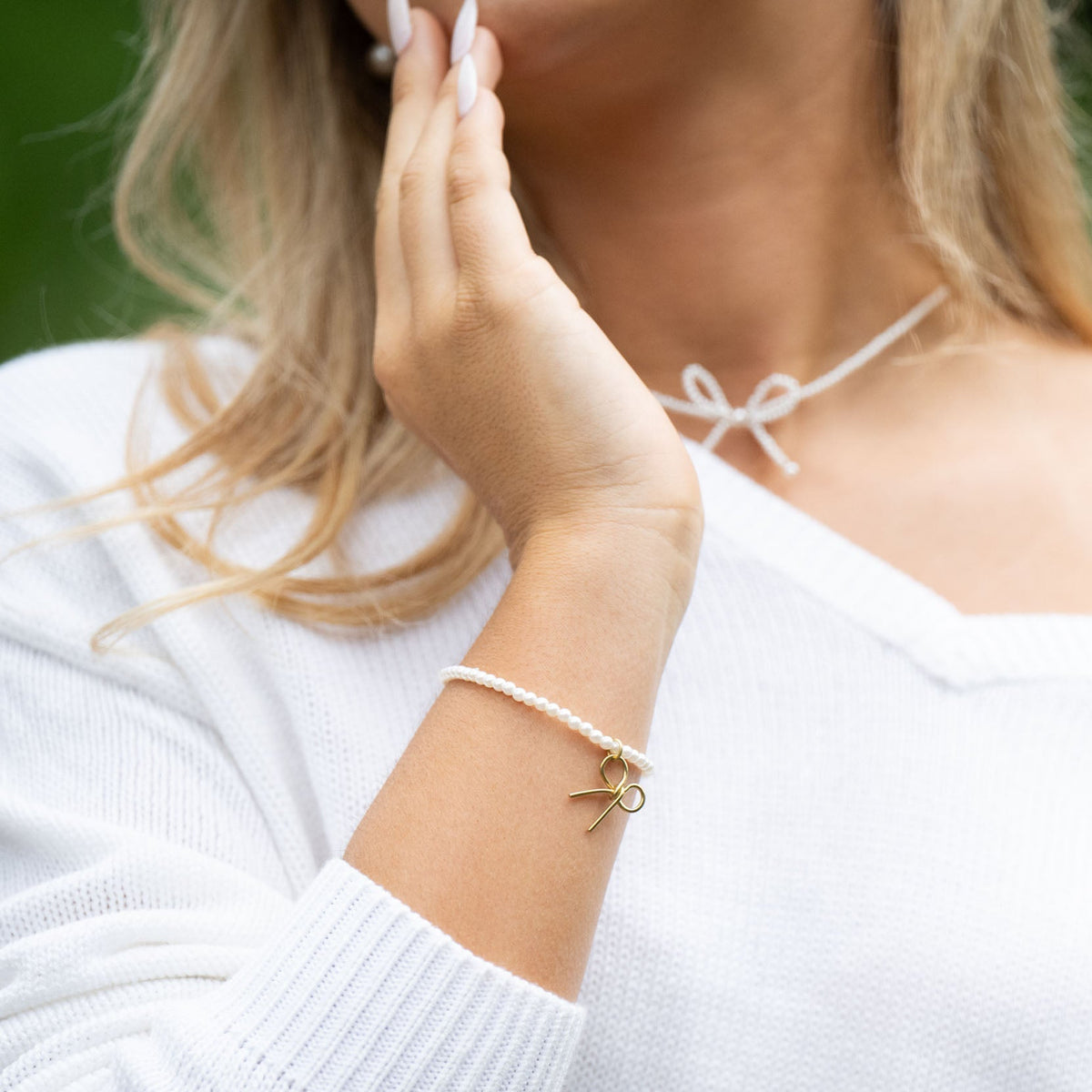 Delicate and timeless, the Pearls &amp; Bow Bracelet features a hand-shaped brass bow paired with dainty faux pearls, creating a piece that adds elegance and charm to any look. The bow symbolizes resilience and the strength of lives beautifully tied together.

Handcrafted by a young woman escaping human trafficking in India, each bracelet carries a story of hope, dignity, and new beginnings. Your purchase supports her journey through our non-profit, International Sanctuary.