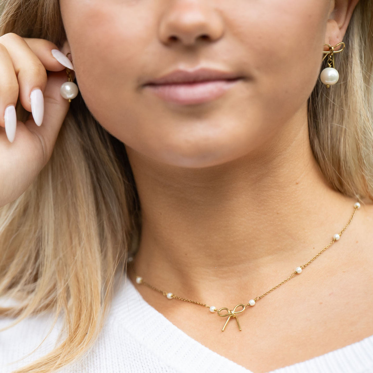 Delicate and timeless, our hand-forged Pearl Bow Studs are perfect for everyday wear. Each stud features a handcrafted brass bow paired with a luminous pearl, securely finished with sterling silver posts.

Every detail—from cutting and hammering to final assembly—is carefully done by a young woman in India rebuilding her life after human trafficking. With each purchase, you support her journey toward hope, dignity, and a brighter future through our non-profit, International Sanctuary.